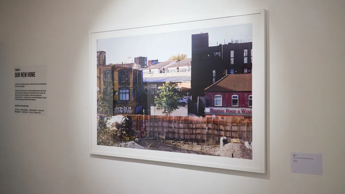 Jack Lee's framed photograph on the wall at the exhibition Re-Place, KOPPEL Collective